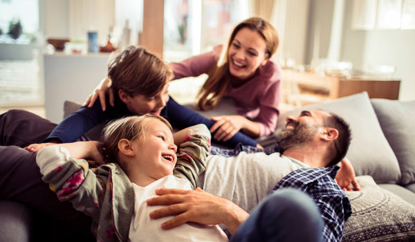 Happy family, smiling and laughing at home.