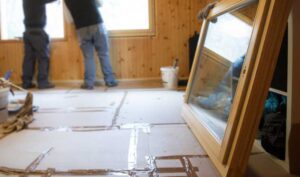 Home building project in progress, with exposed walls and a new window about to be installed.